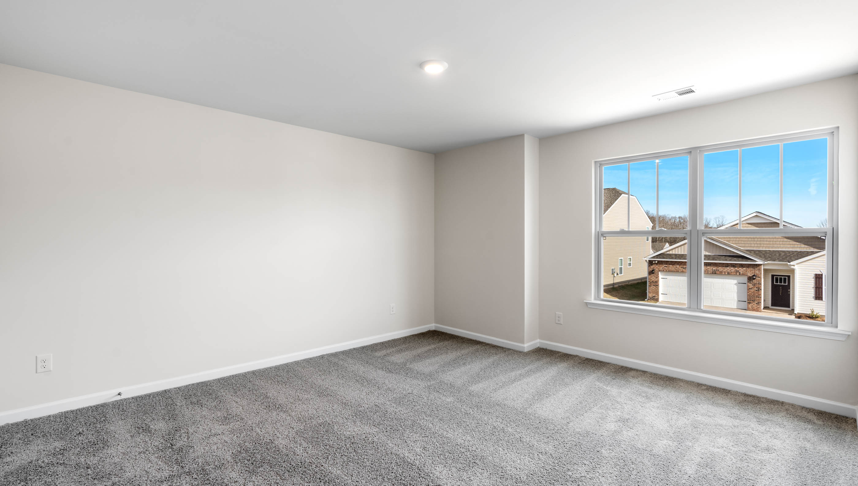 Bedroom with carpet and window.