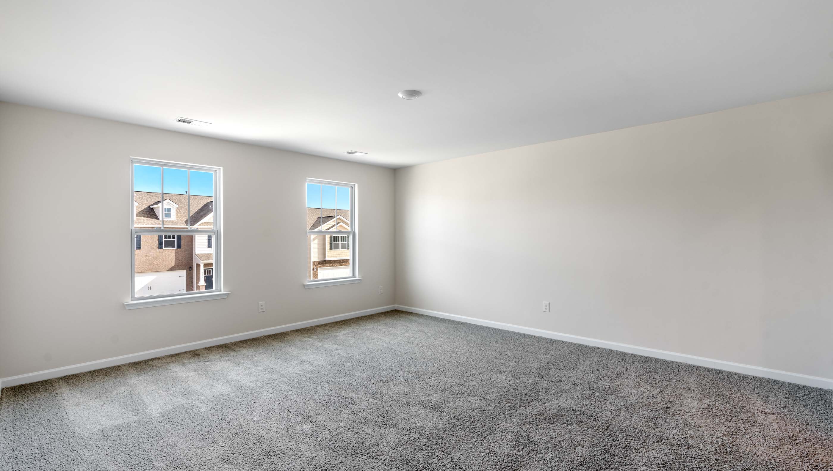 Bedroom with carpet and window.