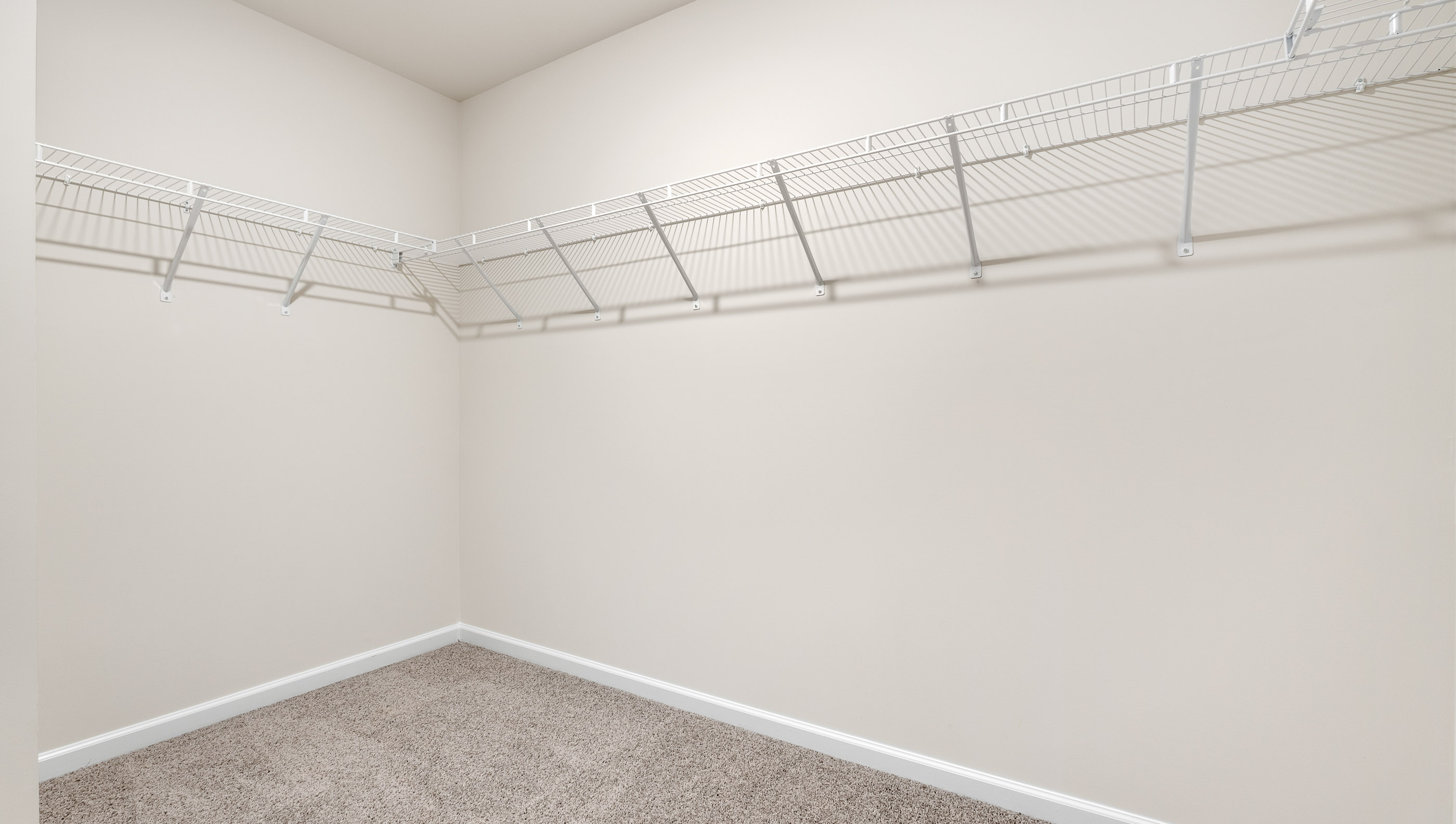 Walk in closet with shelves.