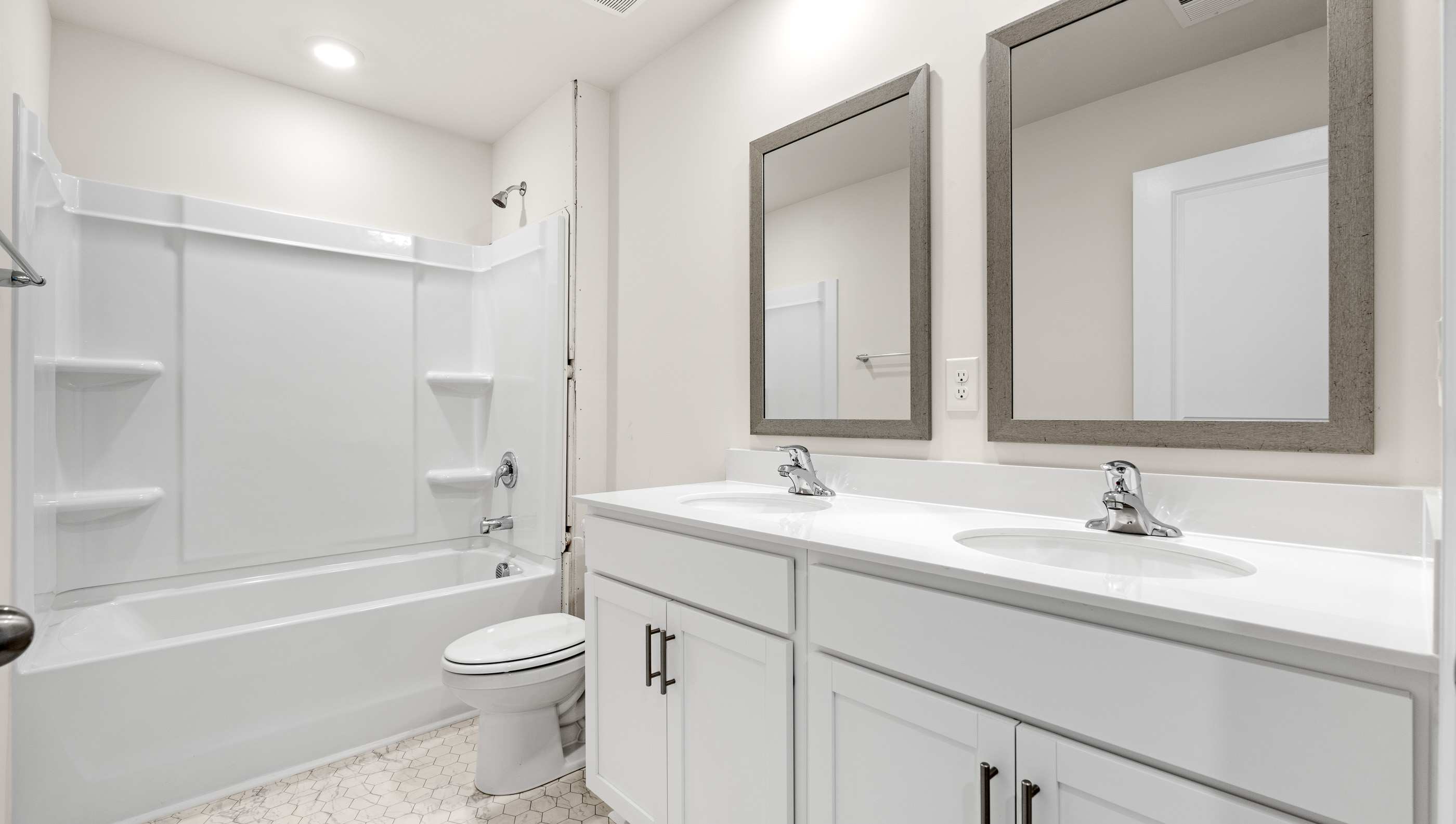 Bathroom with double vanity and tub.