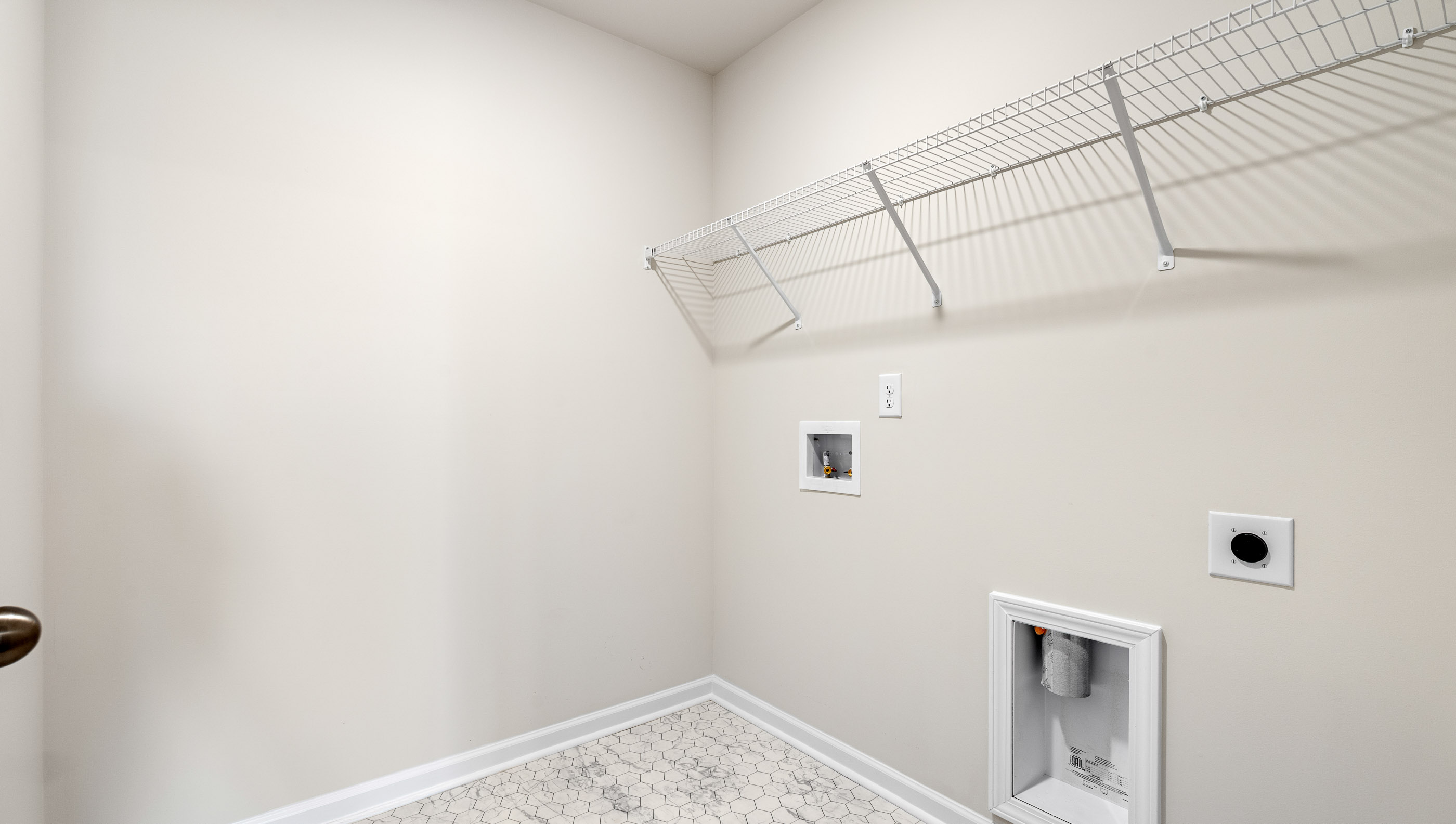 Walk in laundry with shelf.