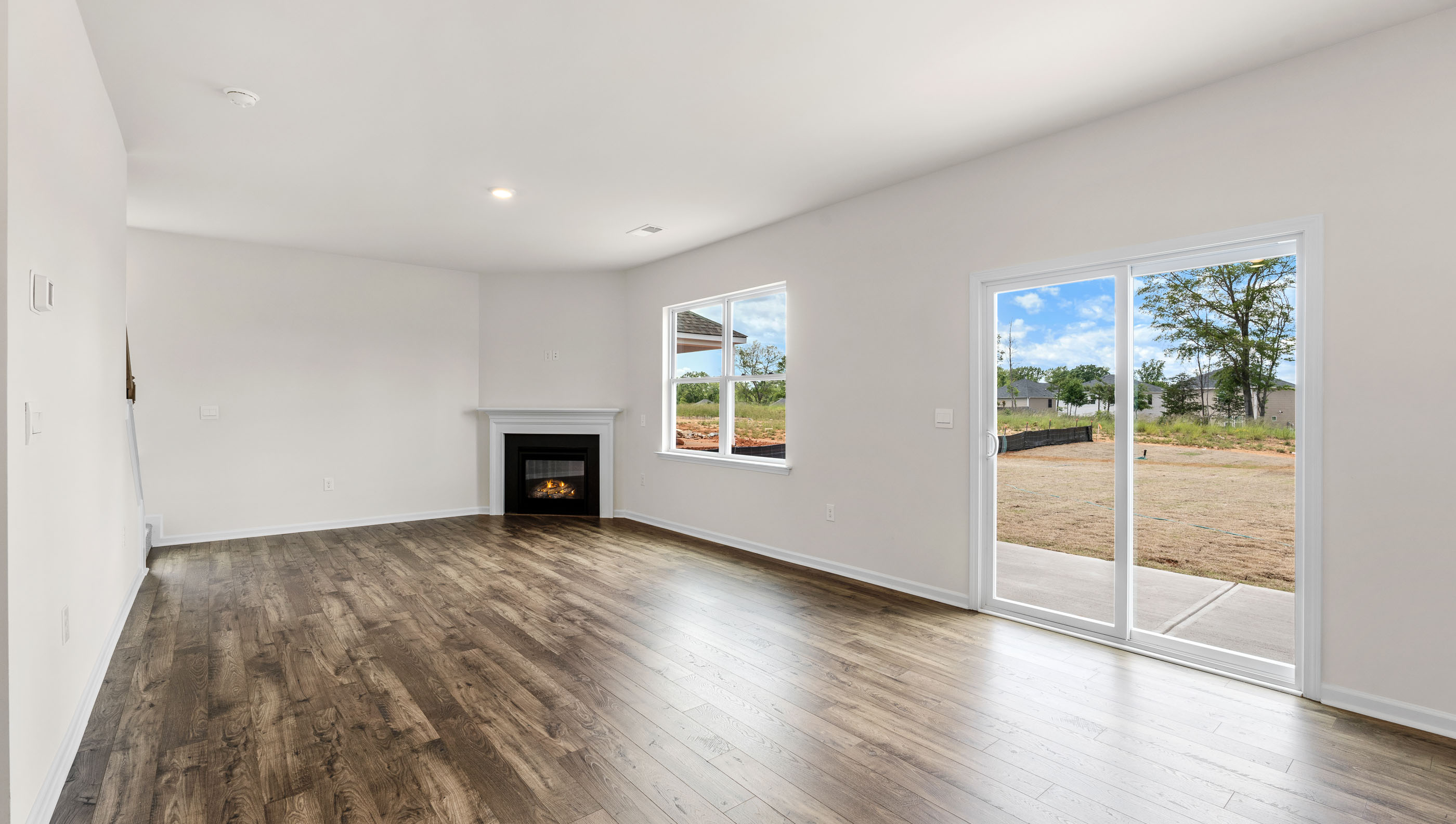 Great Room with fireplace and windows.