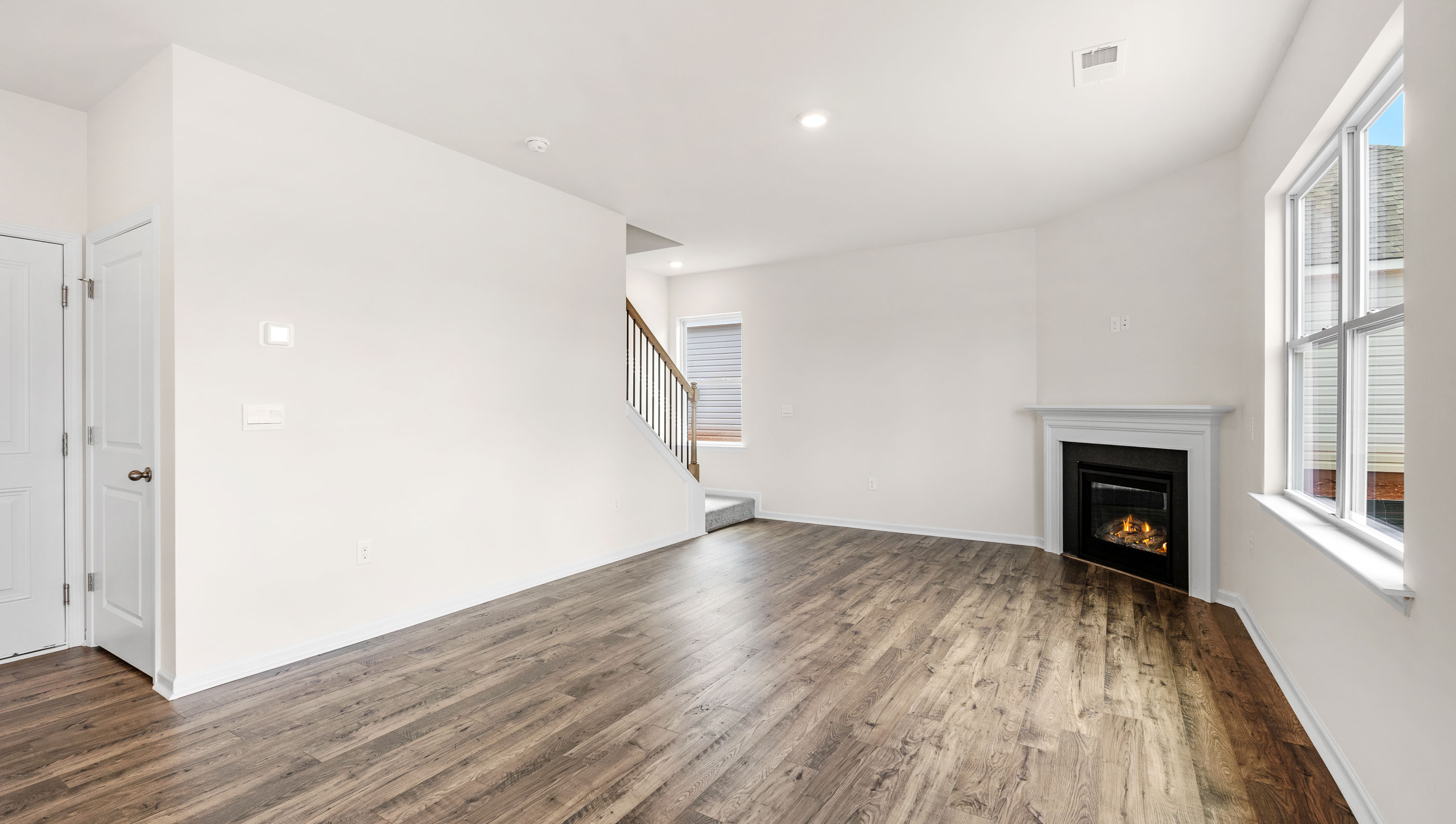 Great Room with fireplace and windows.