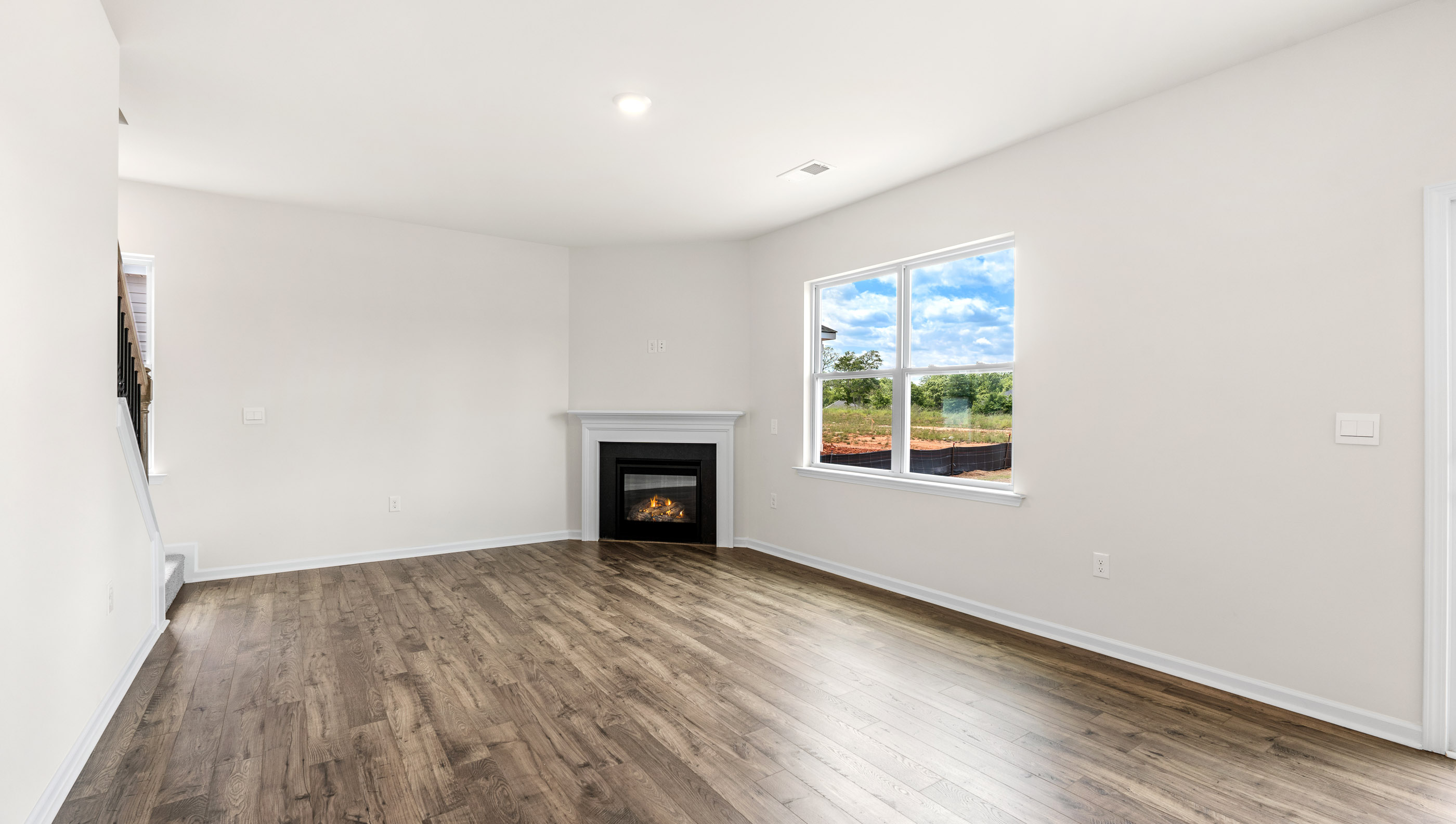 Great Room with fireplace and windows.
