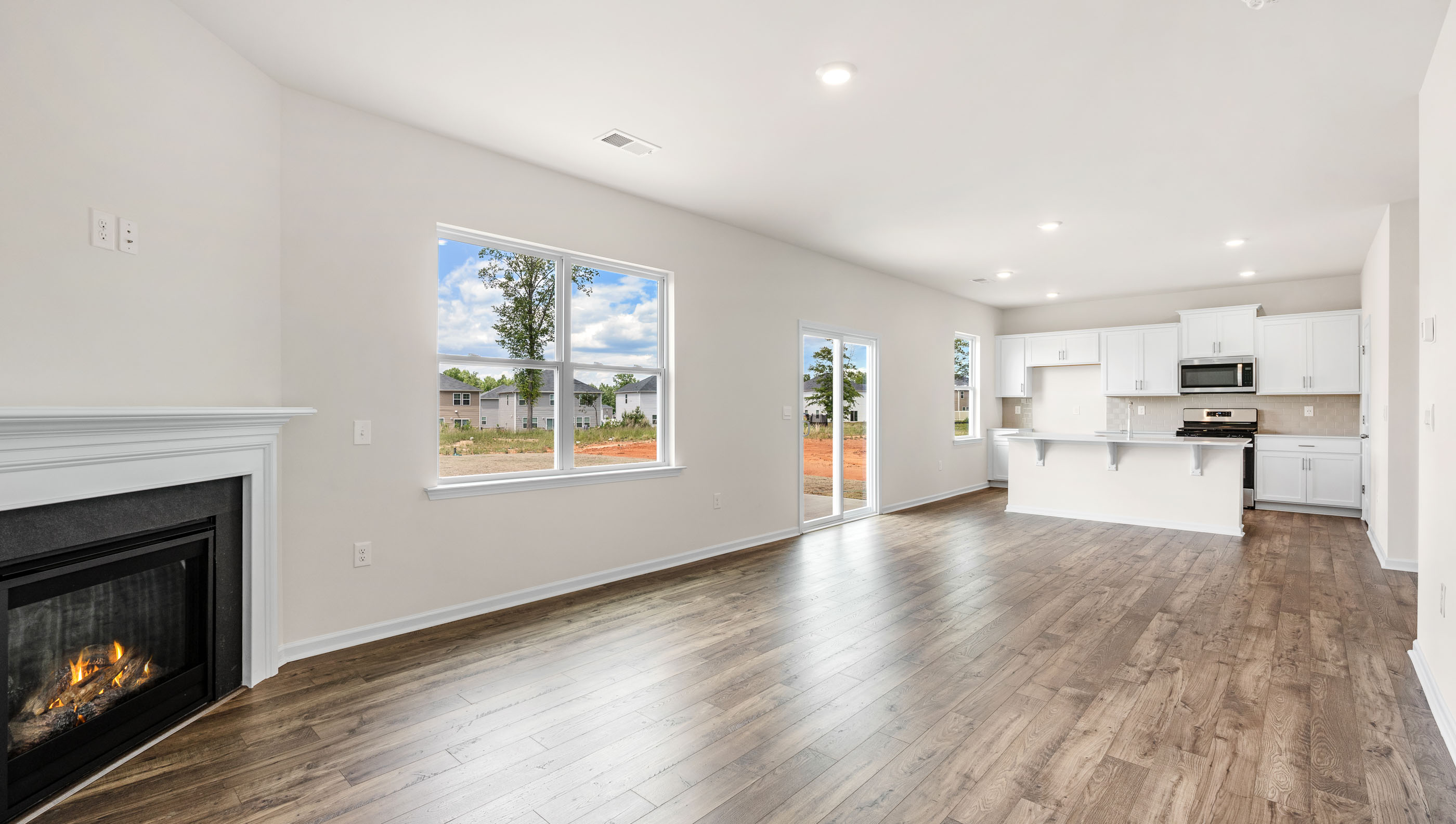 Great Room with fireplace and windows.