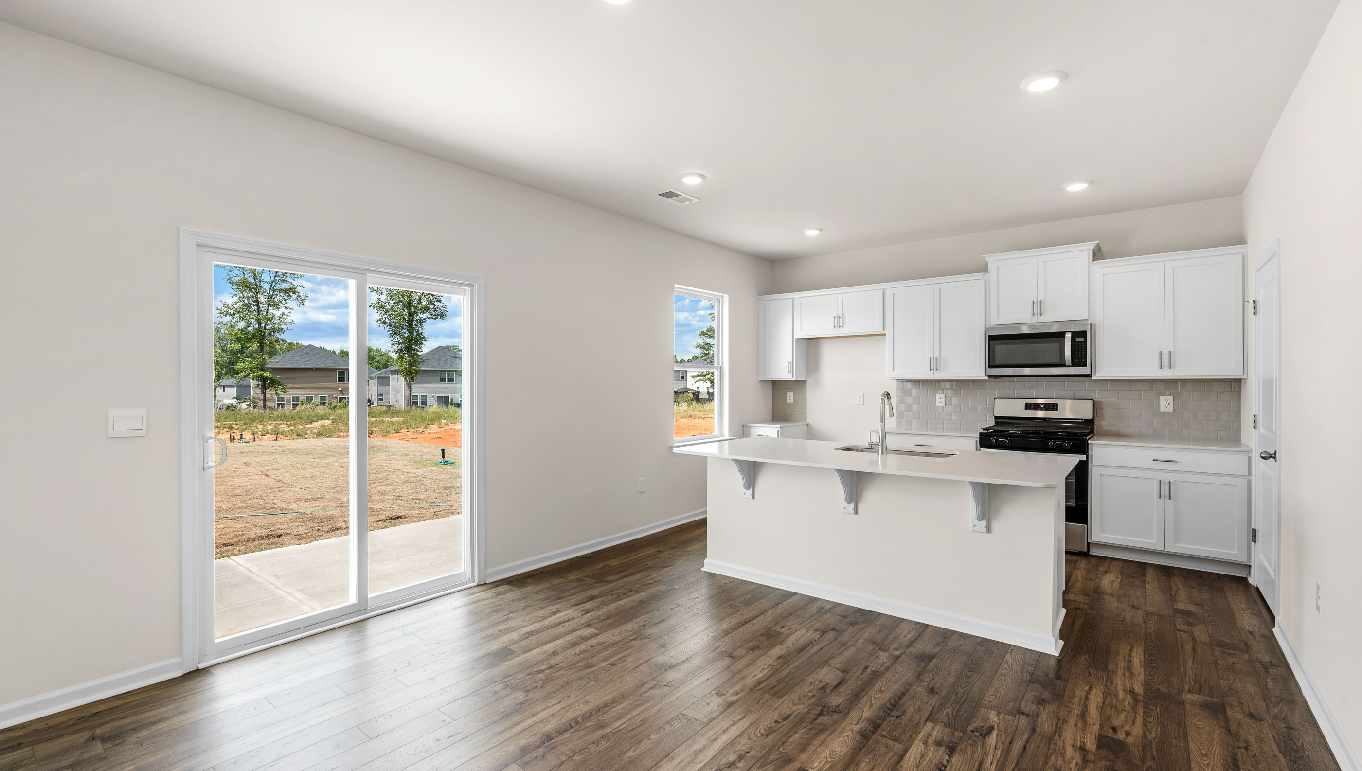 Kitchen and island with granite counter tops.