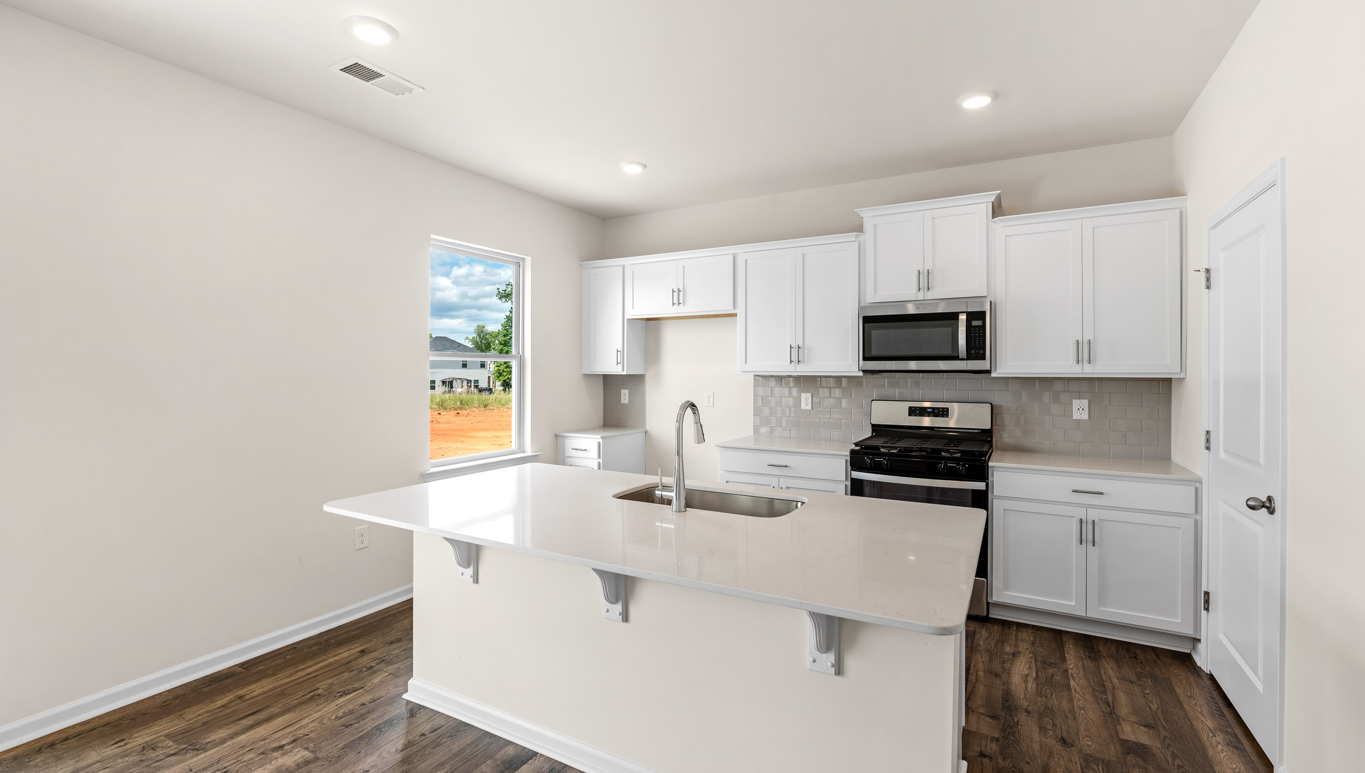 Kitchen and island with granite counter tops.