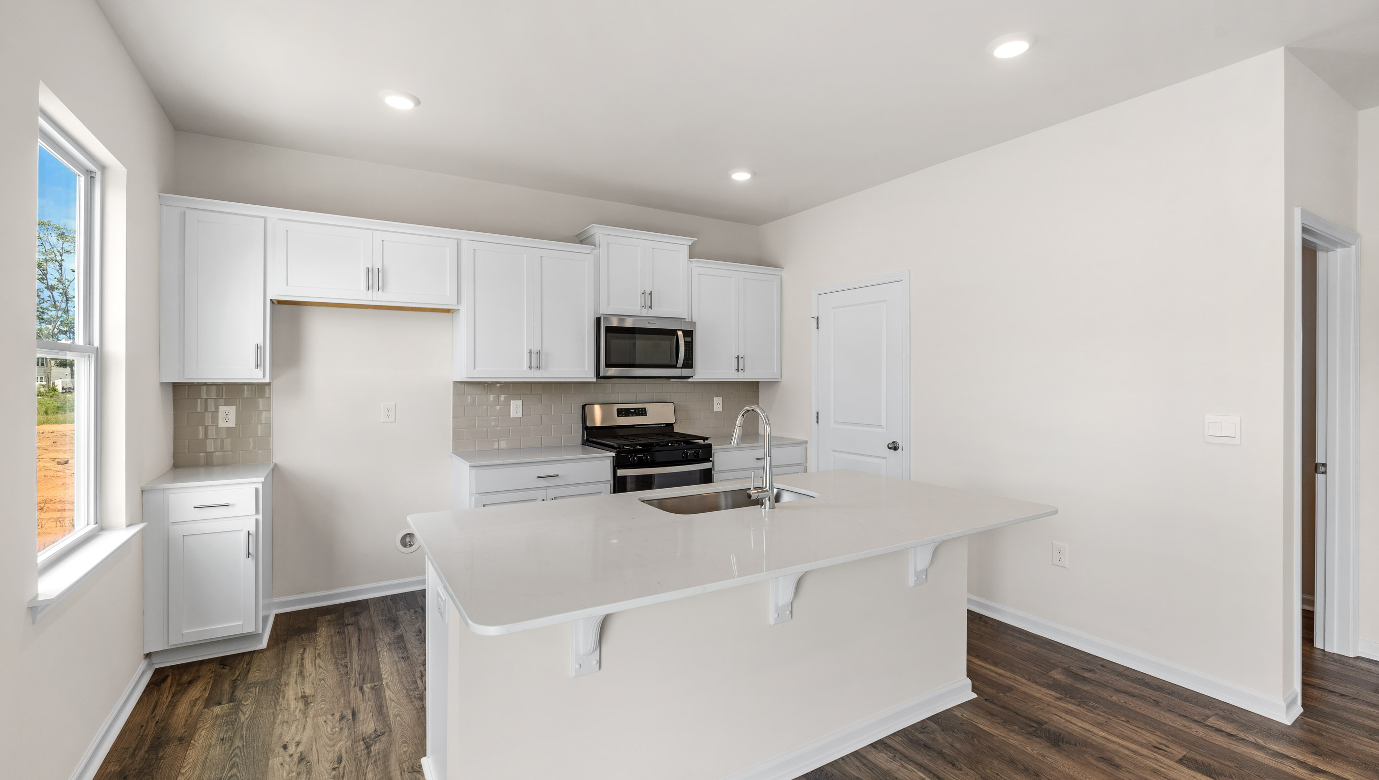 Kitchen and island with granite counter tops.