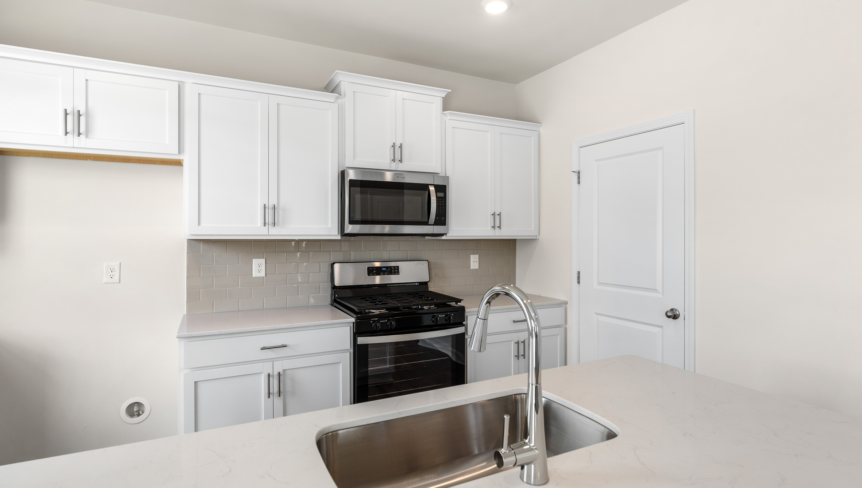 Kitchen and island with granite counter tops.