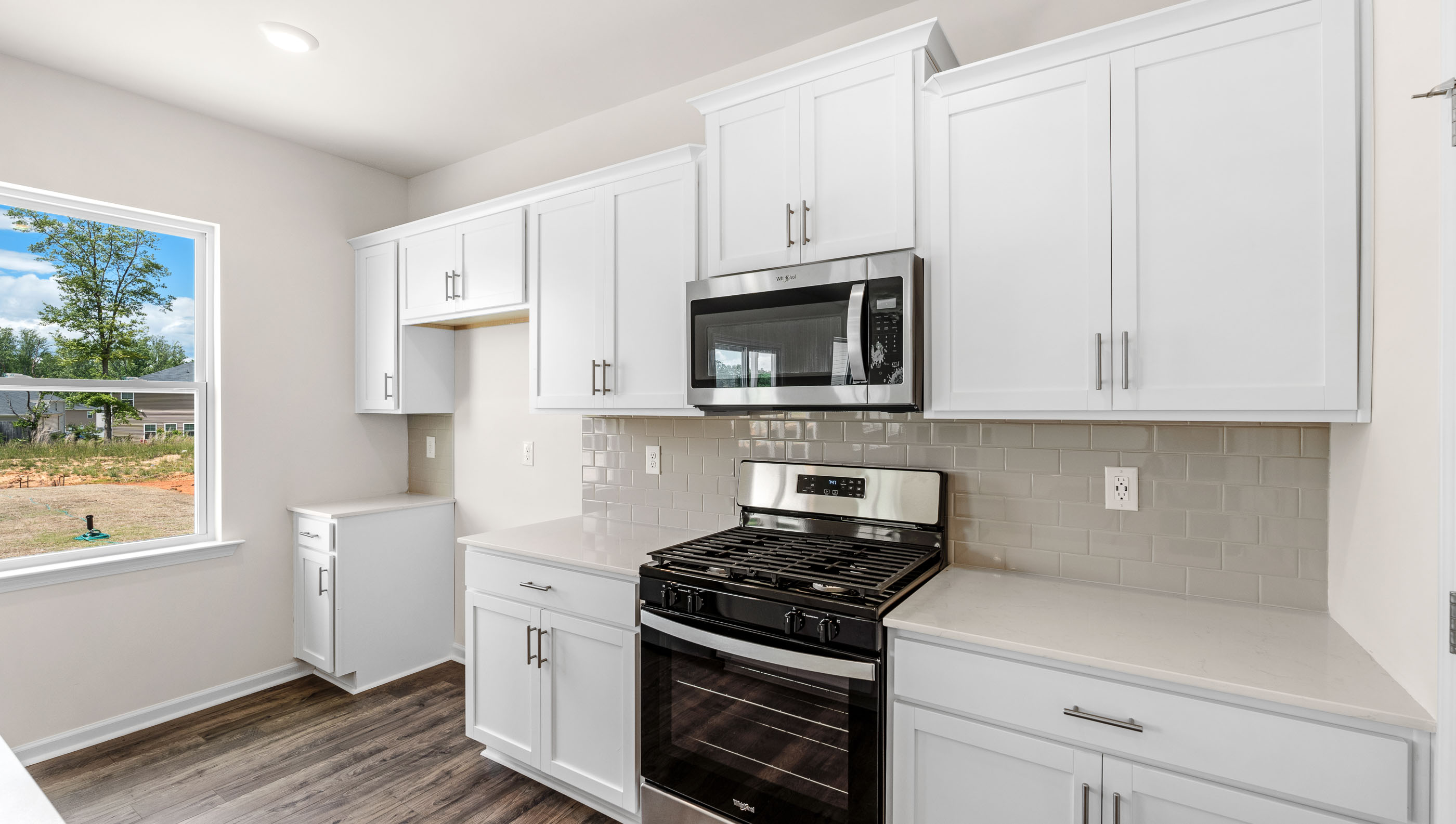 Kitchen with granite counter tops and stainless steel appliances.
