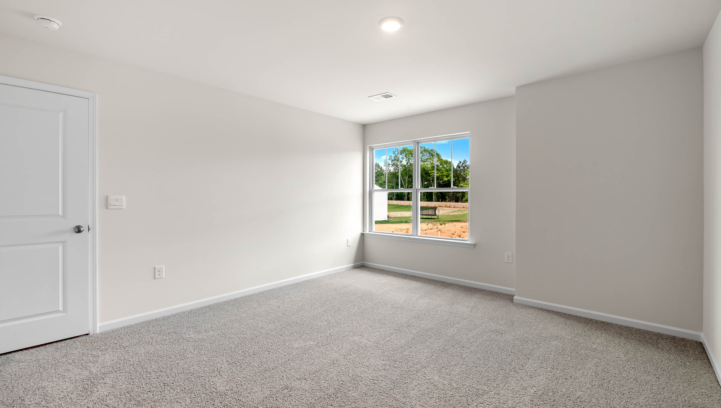 Bedroom with carpet and window.