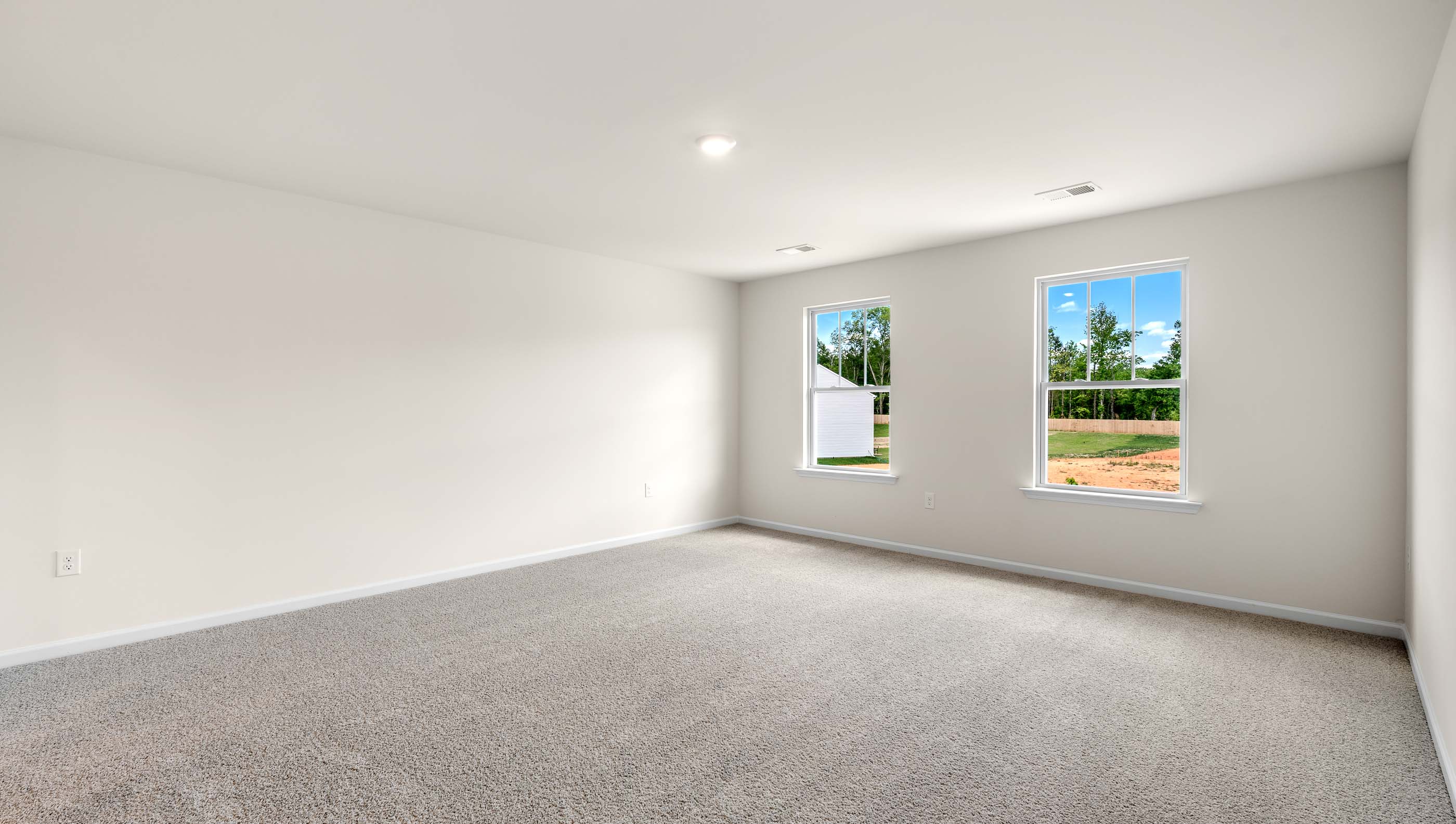 Bedroom with carpet and window.