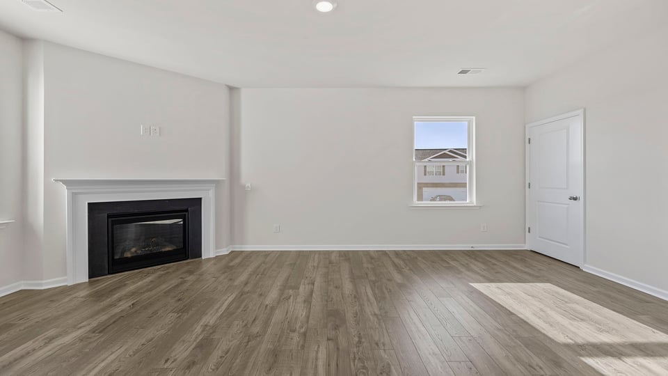 Family room with fireplace and windows.