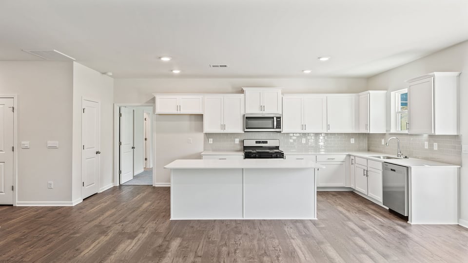 Kitchen and island with granite countertops.