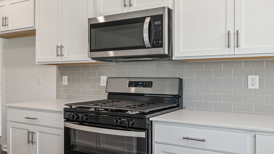 Kitchen with granite countertops and stainless steel appliances.
