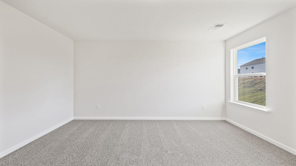 Bedroom with carpet and windows.