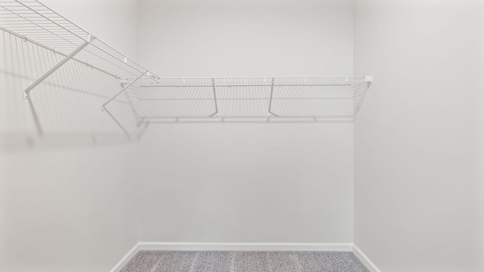 Walk in closet with shelves.