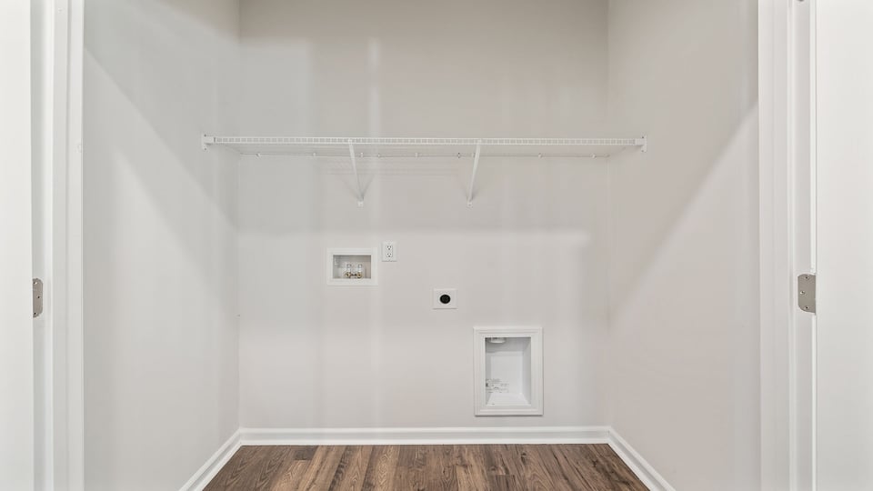 Walk in laundry with shelves.