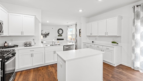 Kitchen with granite counter tops and white cabinets.