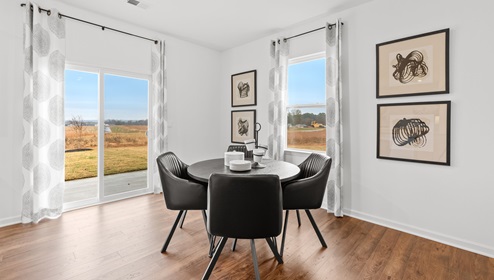 Dining area in kitchen with door to backyard.