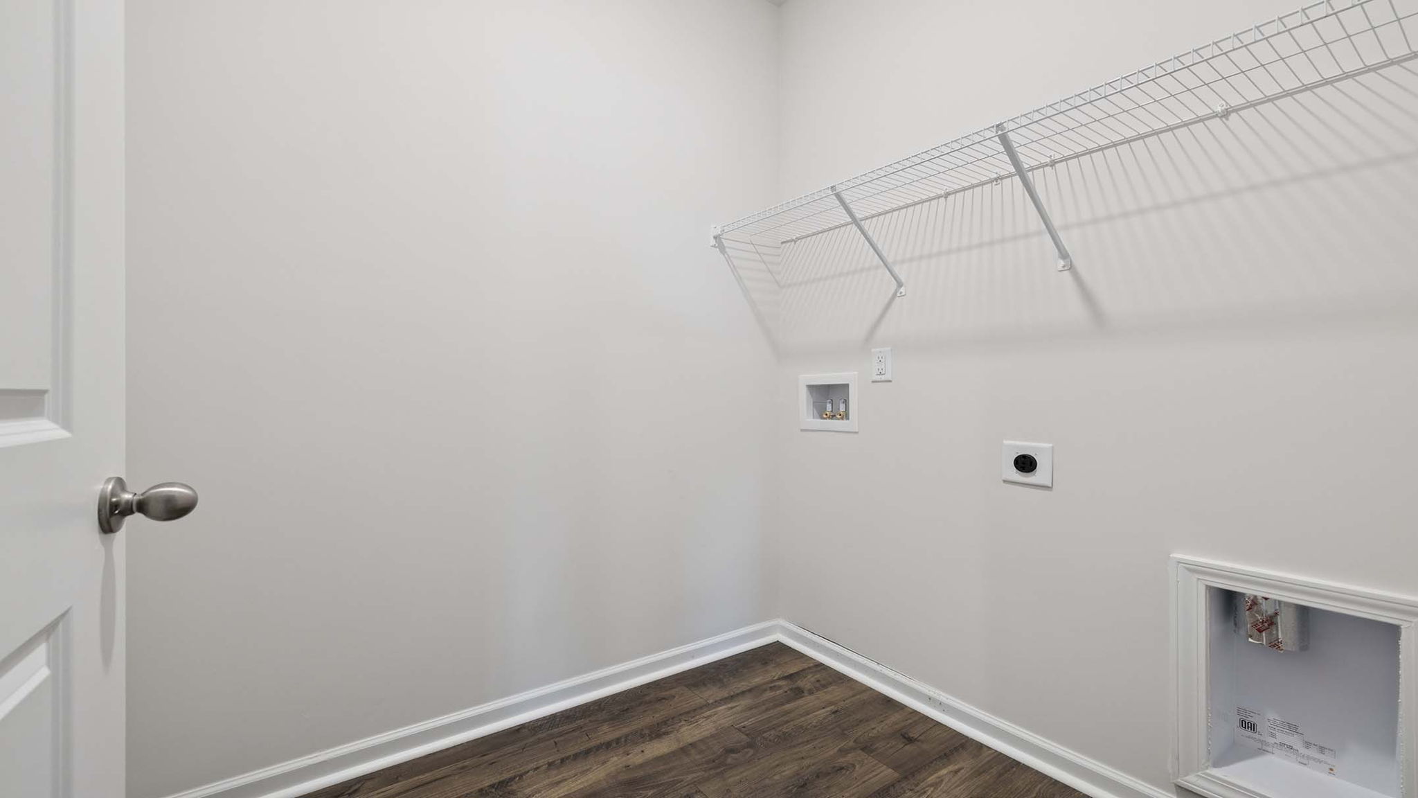 Walk in laundry with shelves.