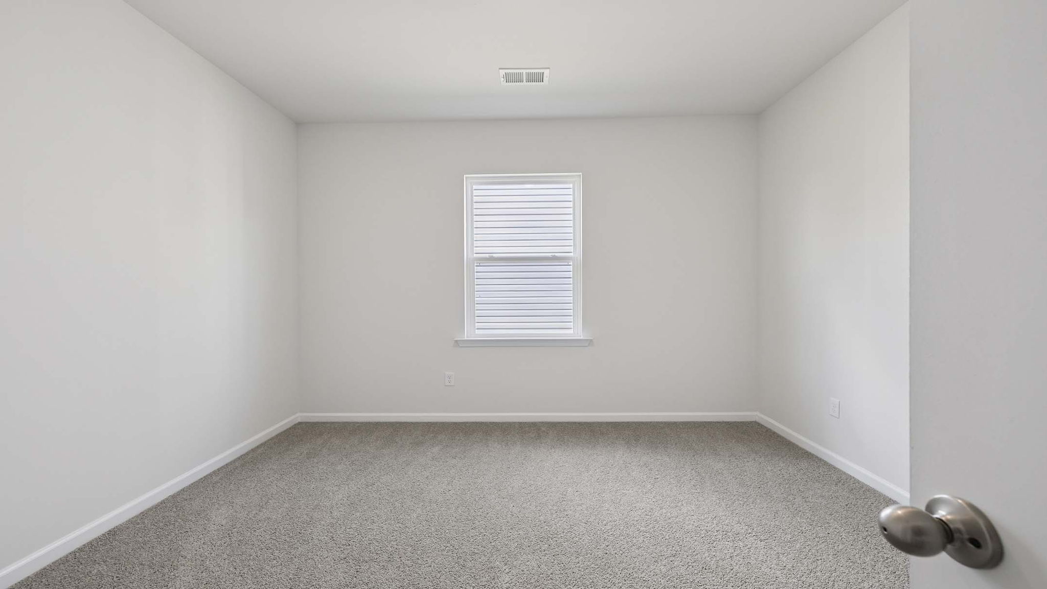Bedroom with carpet and windows.