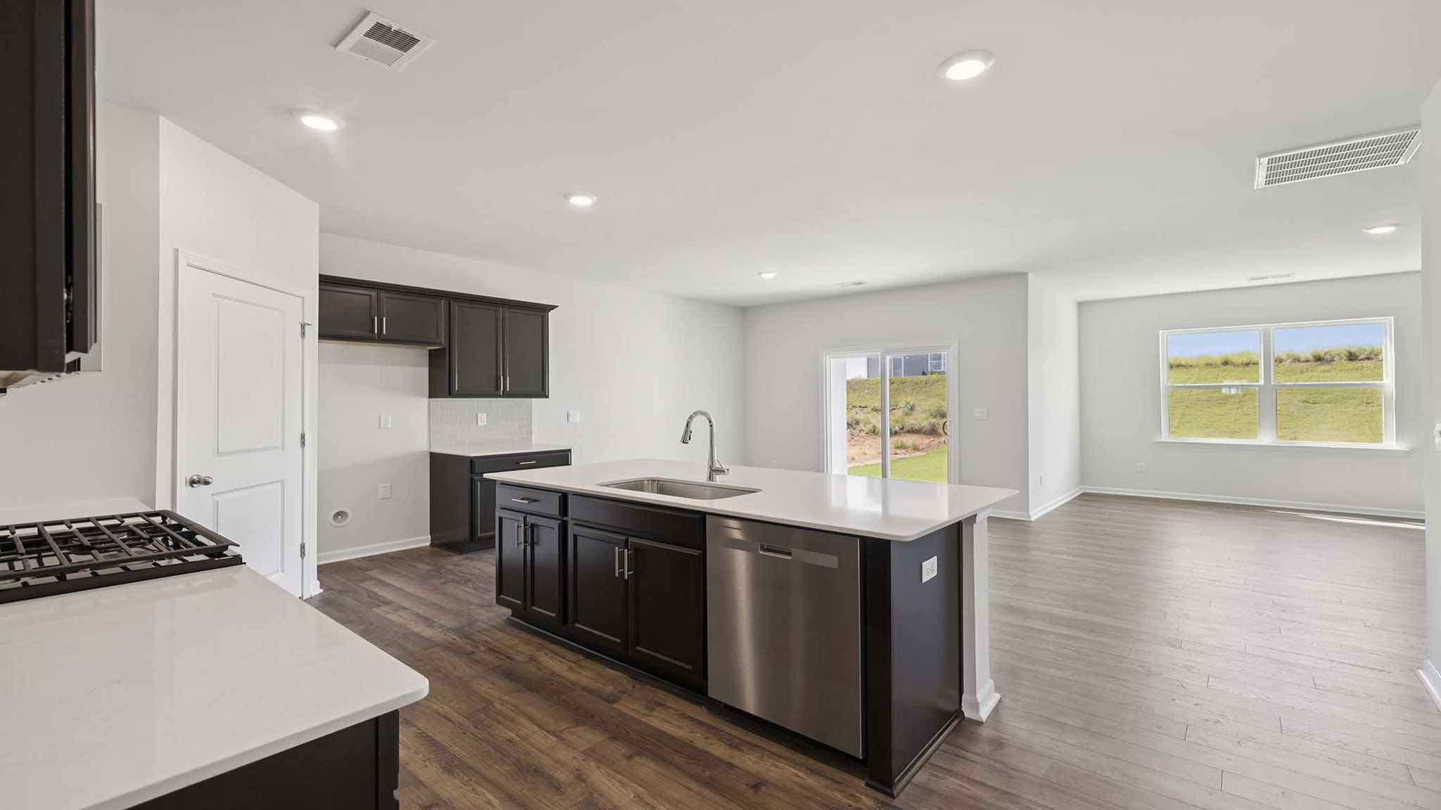 Kitchen and island with granite countertops.