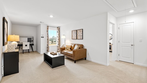 Loft area with carpet and windows.