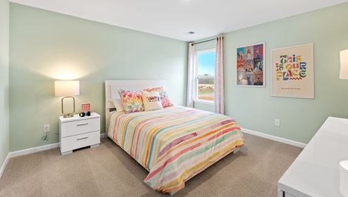 Bedroom with carpet and window.