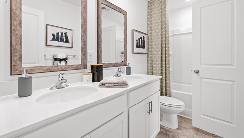 Bathroom with double vanity sink and bathtub.