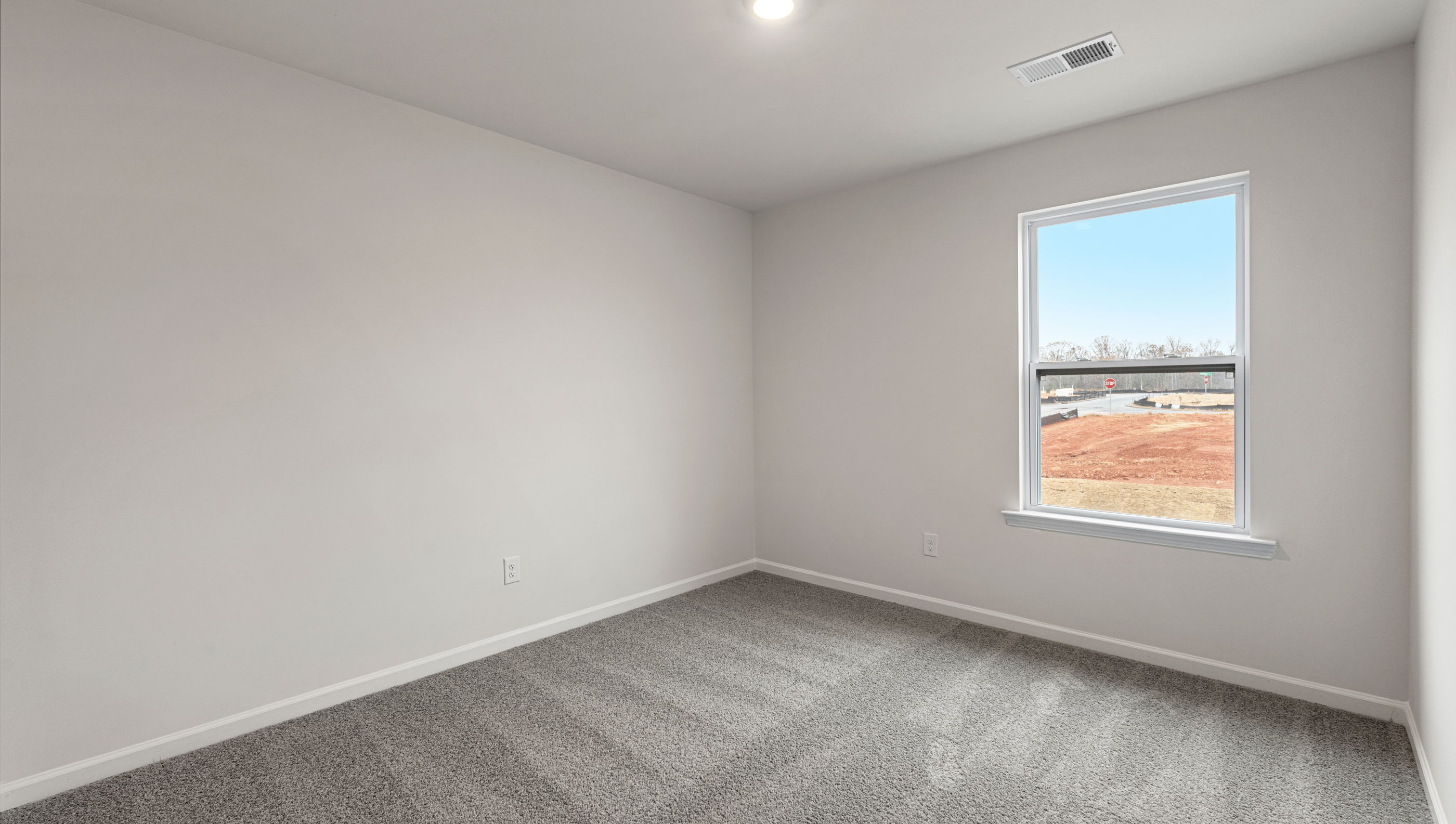 Bedroom with carpet and window.