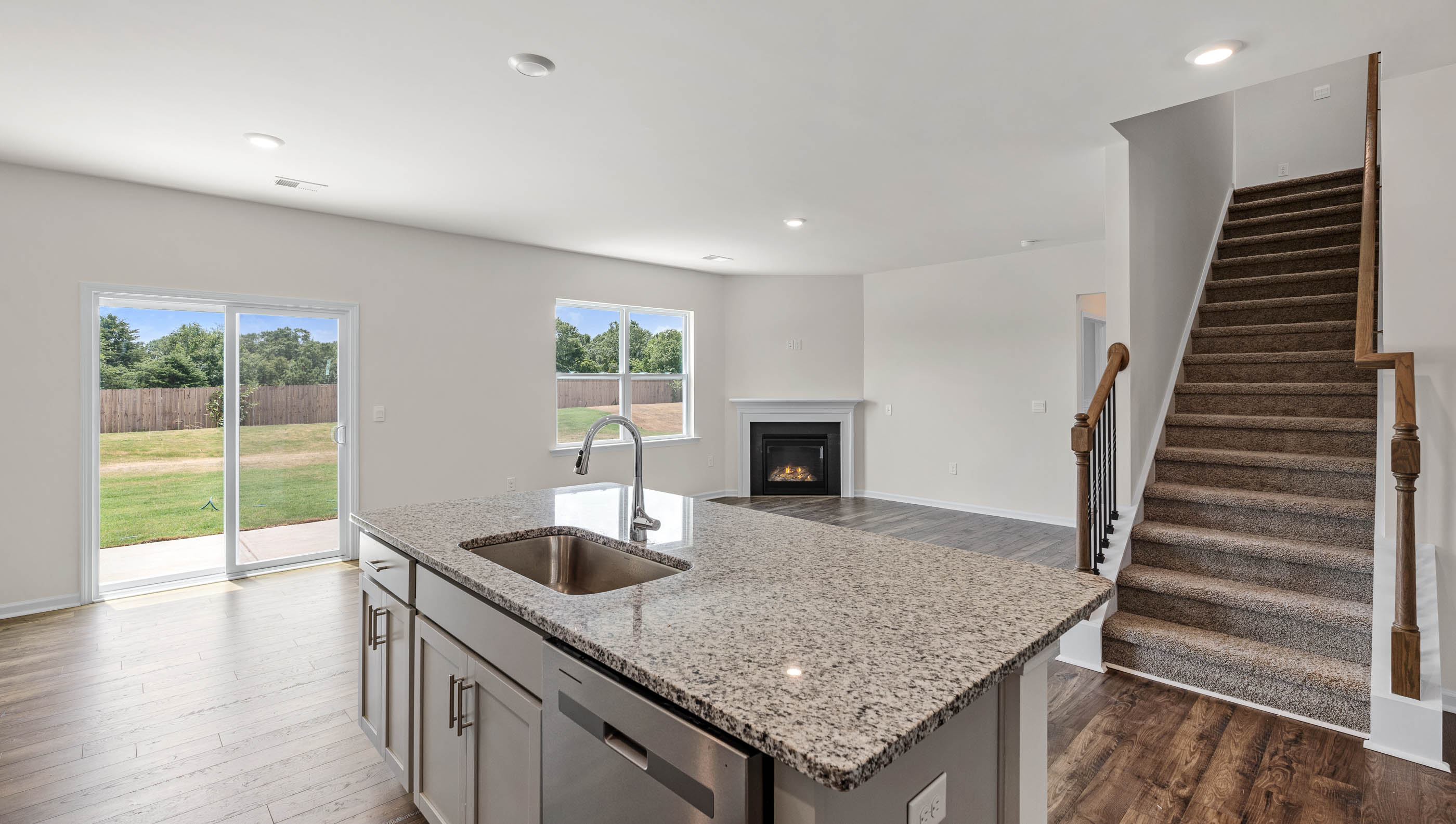 Kitchen and island with stainless steel appliances.