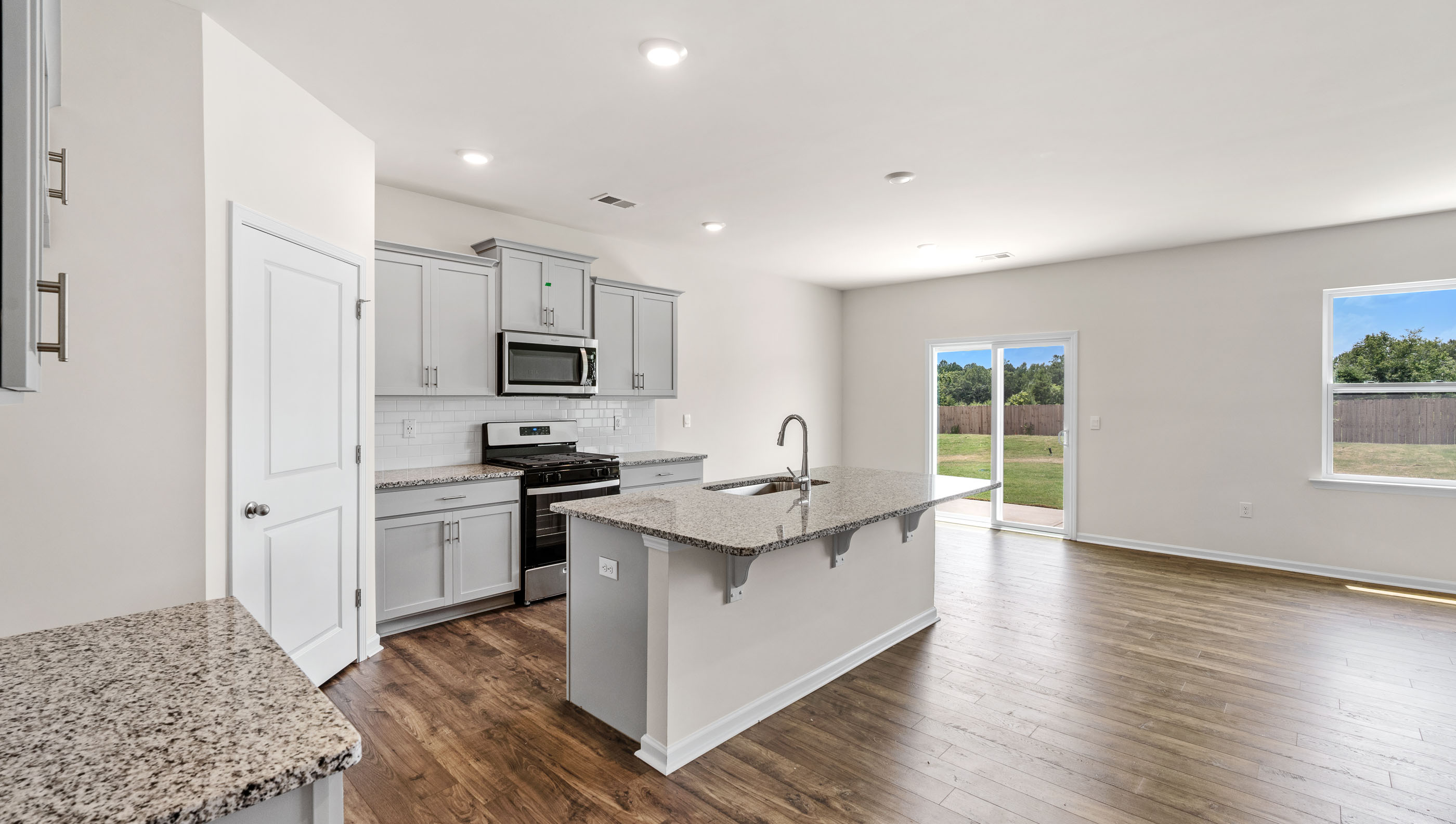 Kitchen with island and granite countertops.