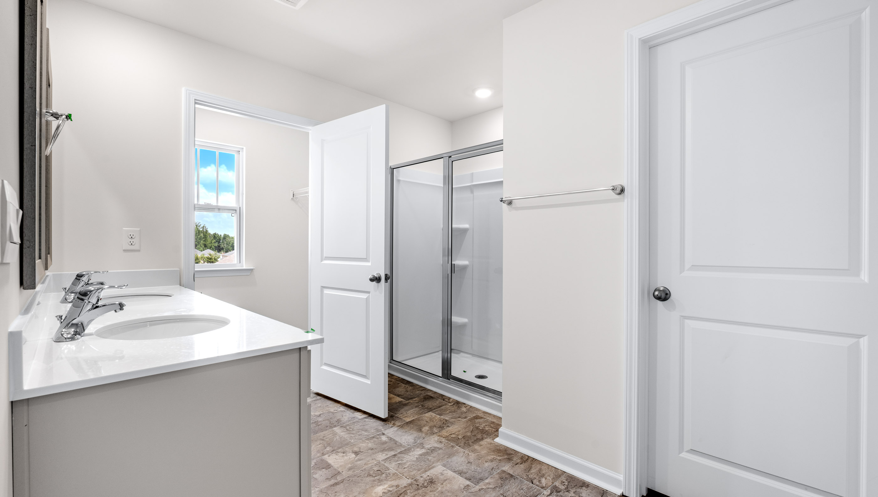Bathroom with vanity and walk in shower.