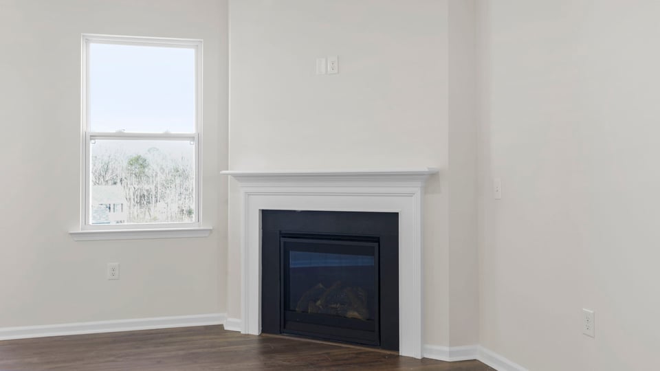 Family room with fireplace and windows.