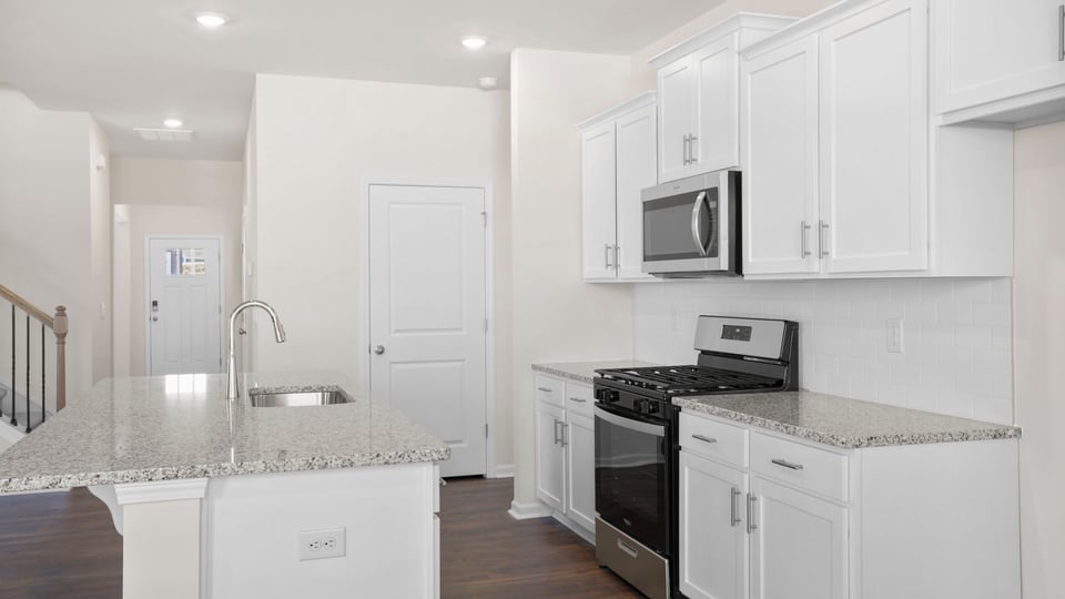 Kitchen and island with granite countertops.