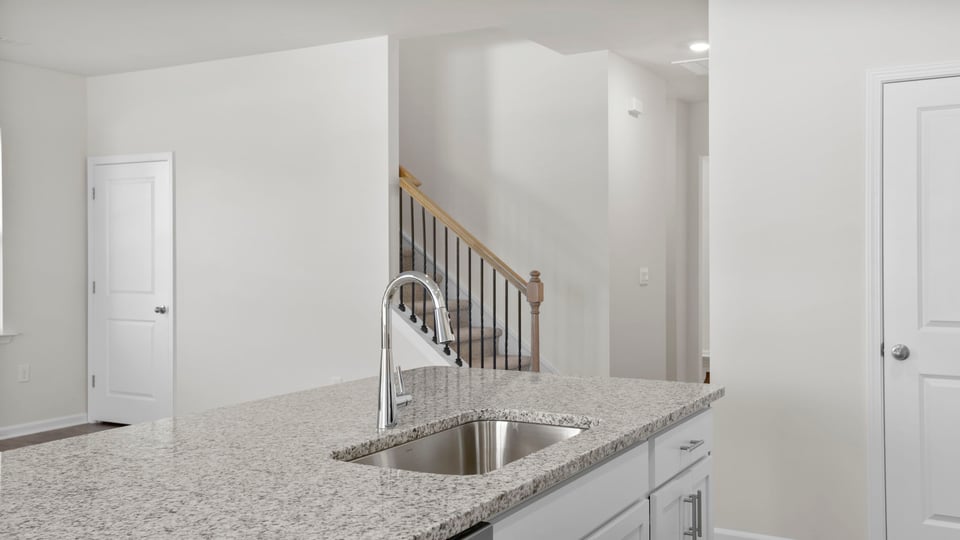 Kitchen and island with granite countertops.