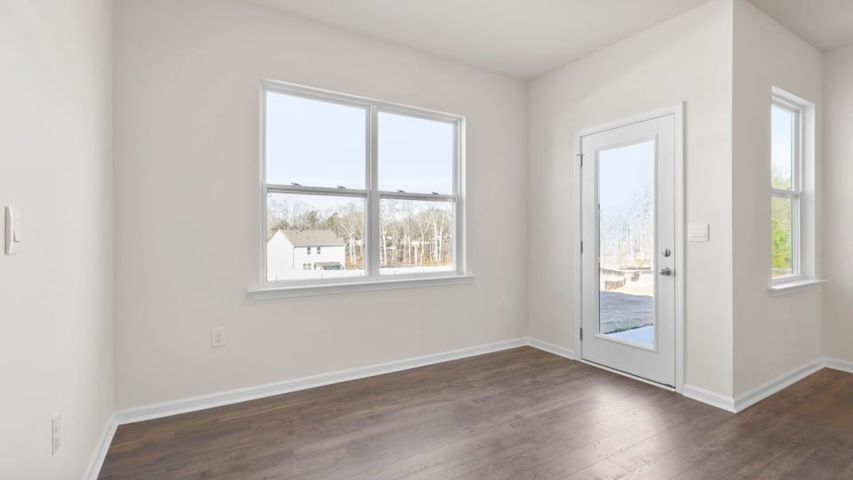 Casual dining area with windows and door.