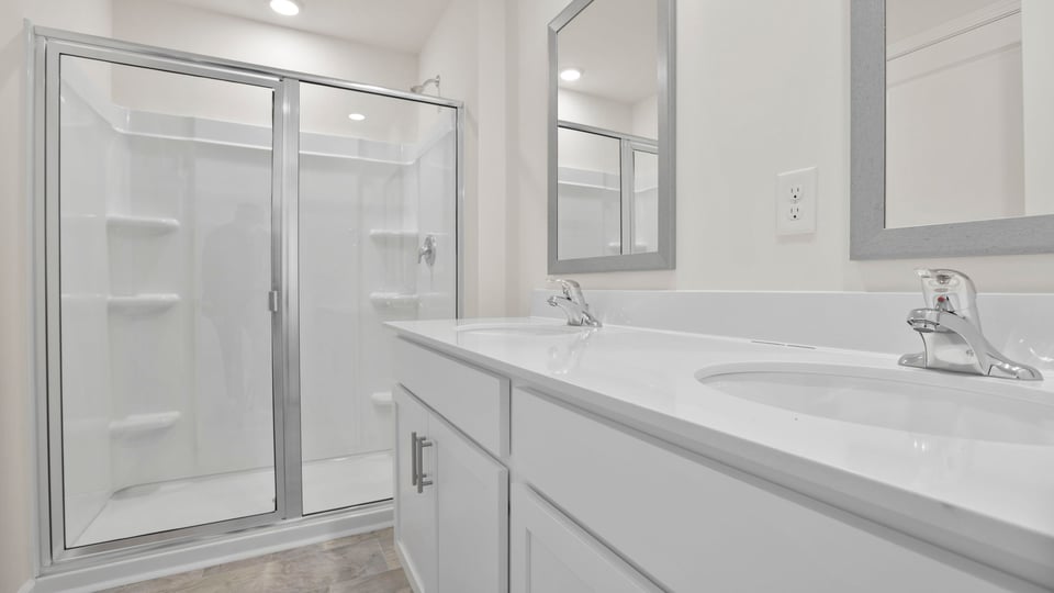 Bathroom with dual vanity and walk in shower.