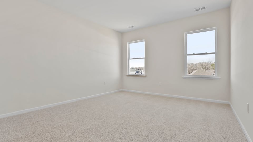 Bedroom with carpet and window.