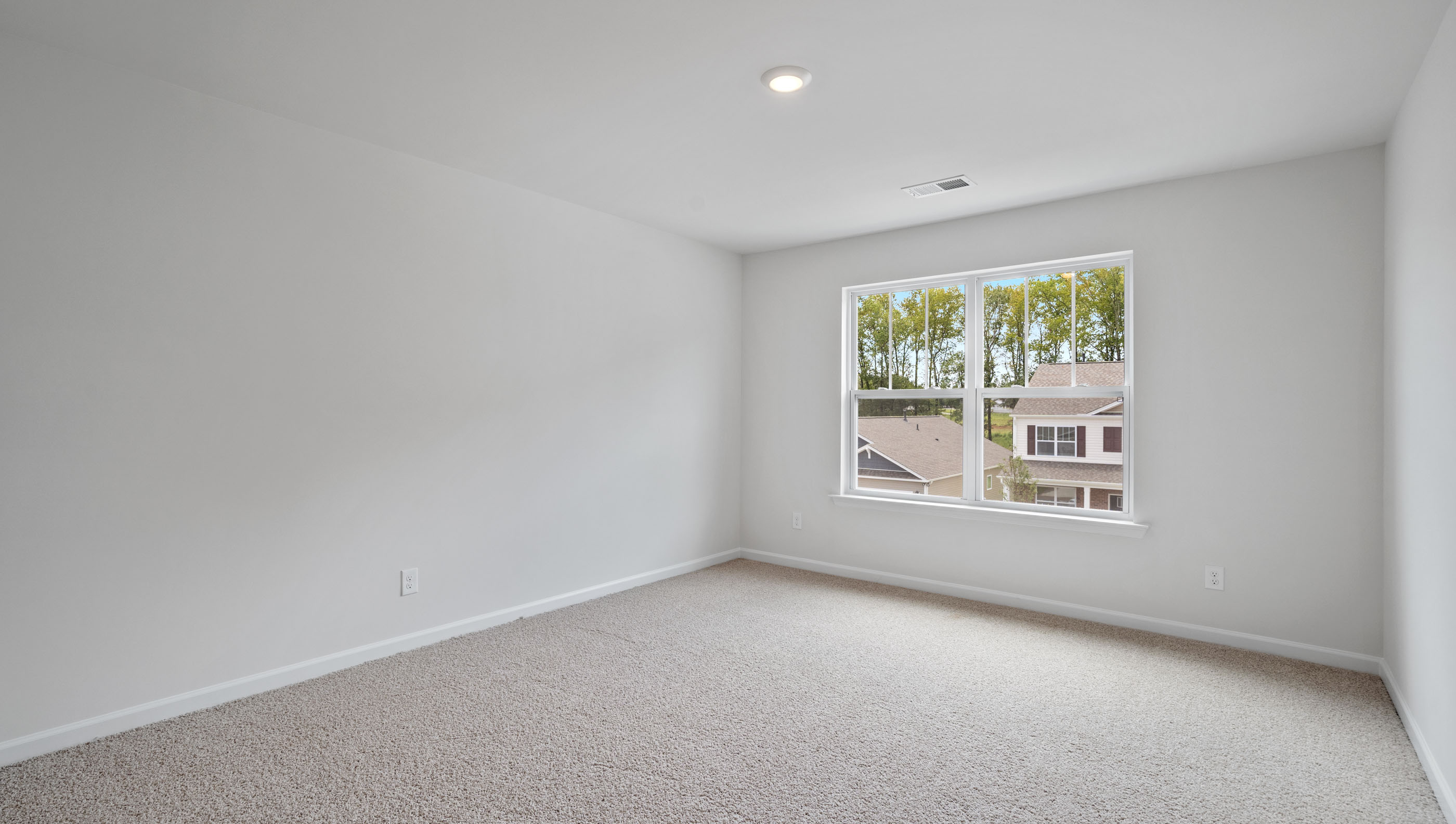 Bedroom with carpet and window.