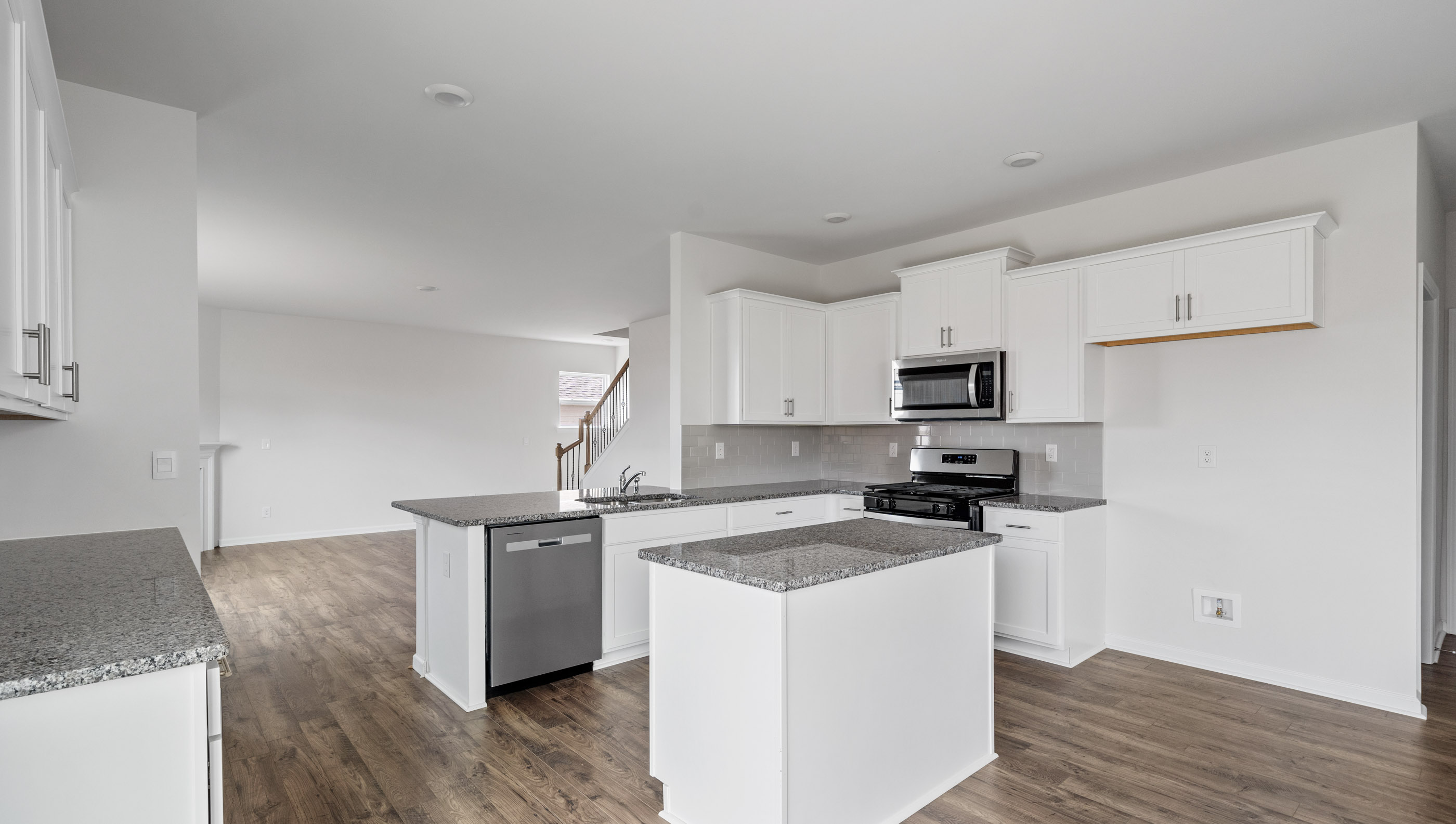 Kitchen and island with granite countertops.