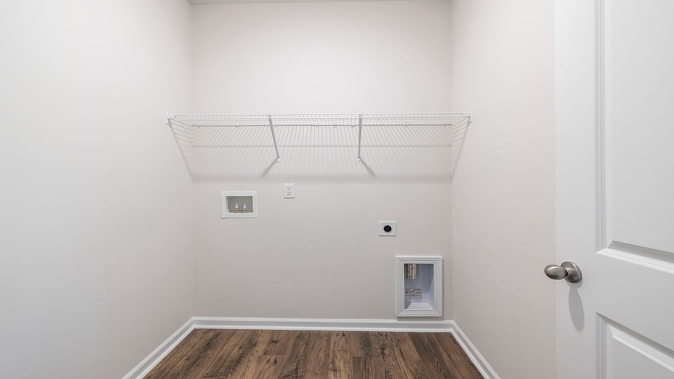 Walk in laundry with hanging shelves.