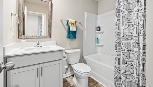 Bathroom with single vanity and tub.