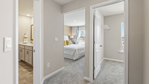 Hallway with view of room, bathroom and closet.