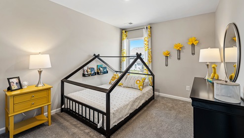 Bedroom two with carpet and window.