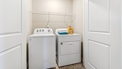 Laundry room closet with storage racks.