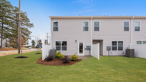 Exterior patio of model home with backyard.