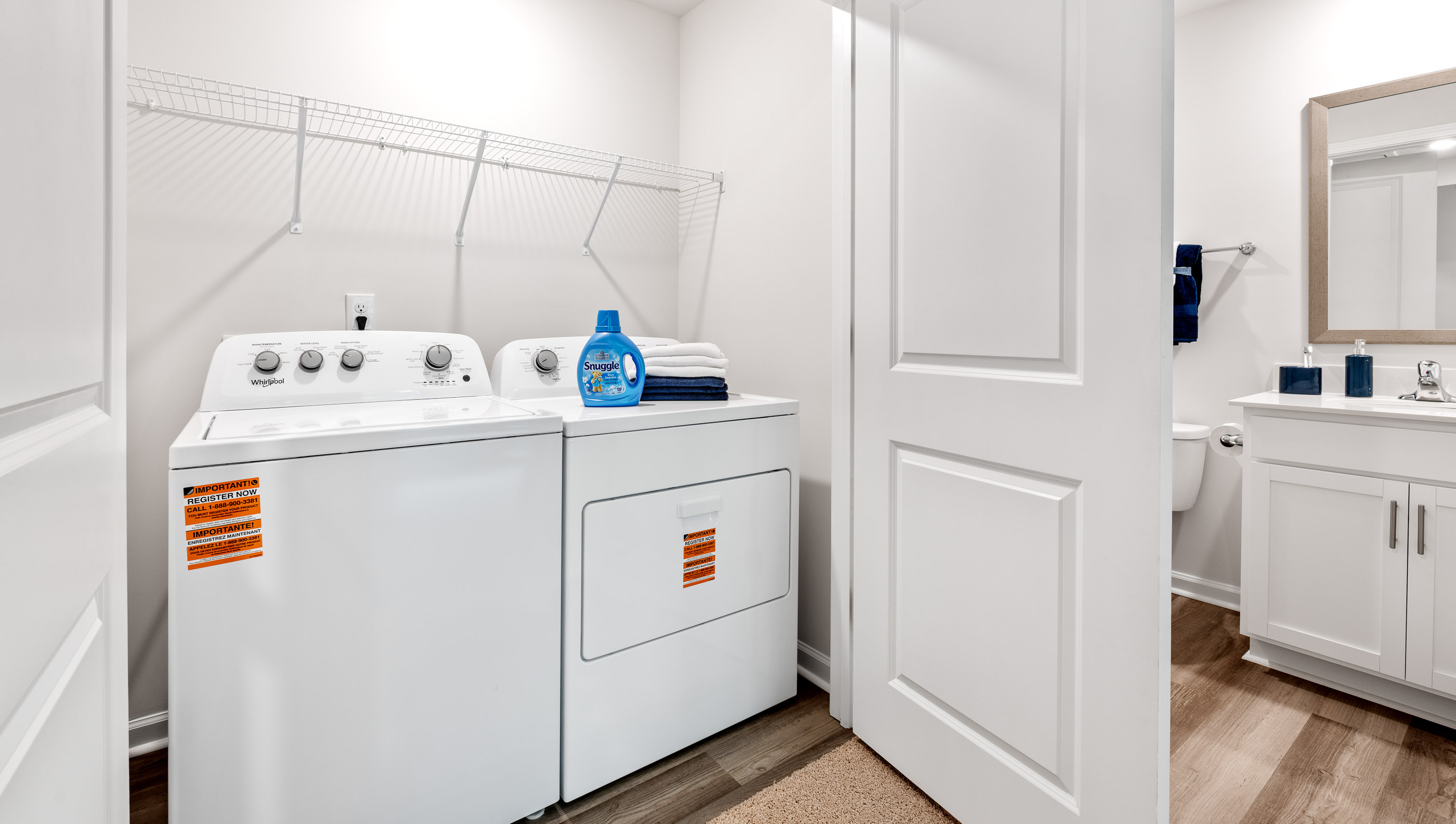Laundry room with hanging storage racks.