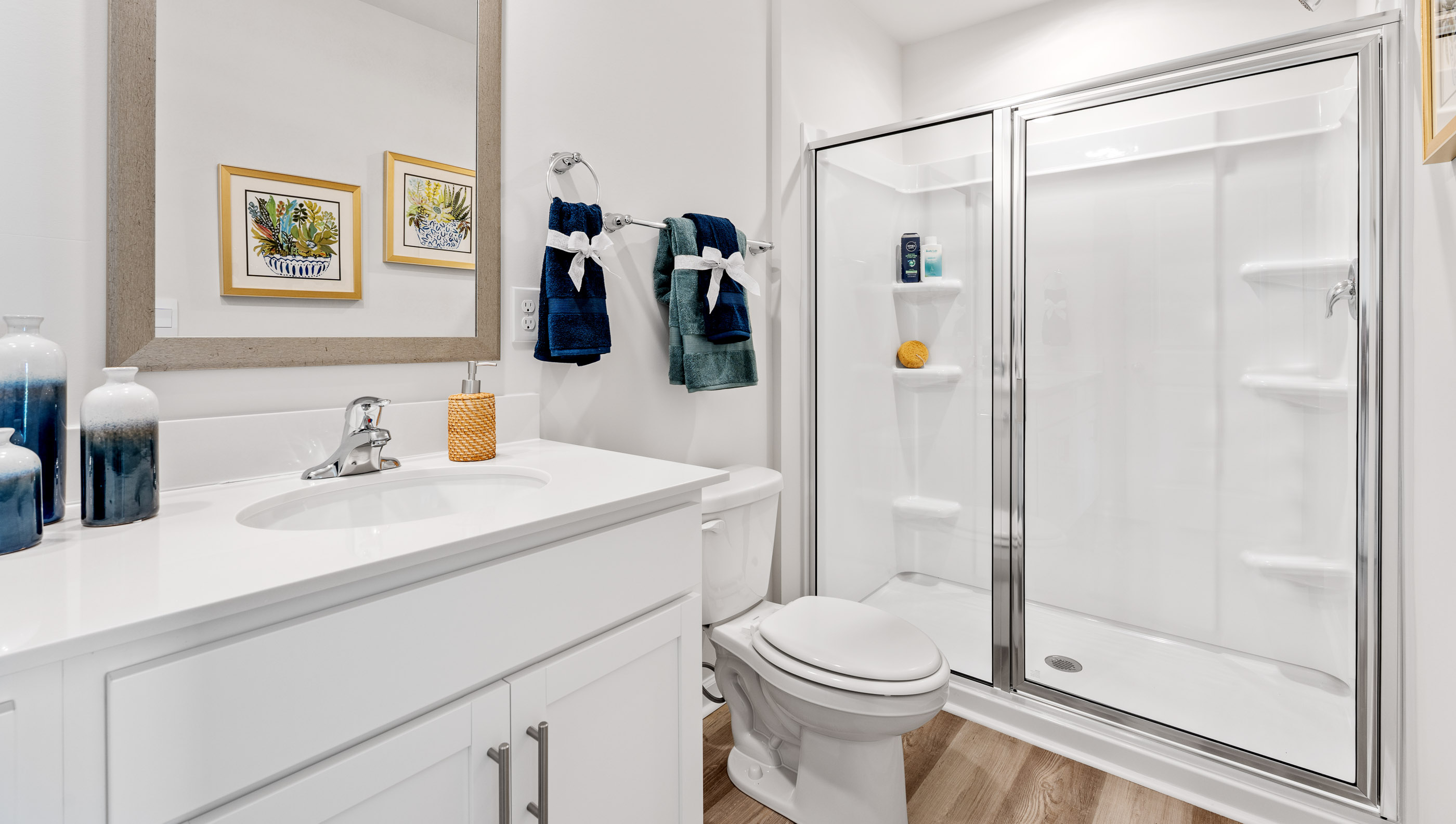 Bathroom with double vanity sink and walk in shower.